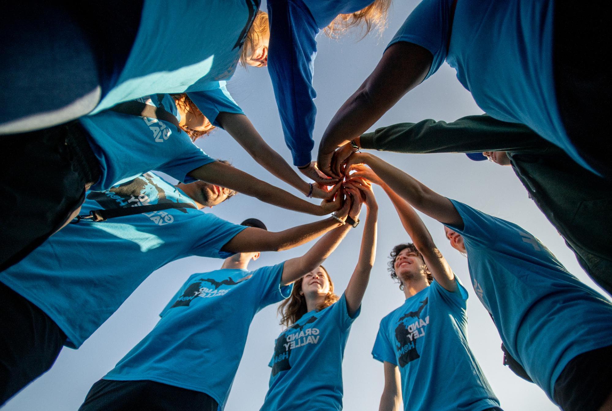 Group of students doing a handshake